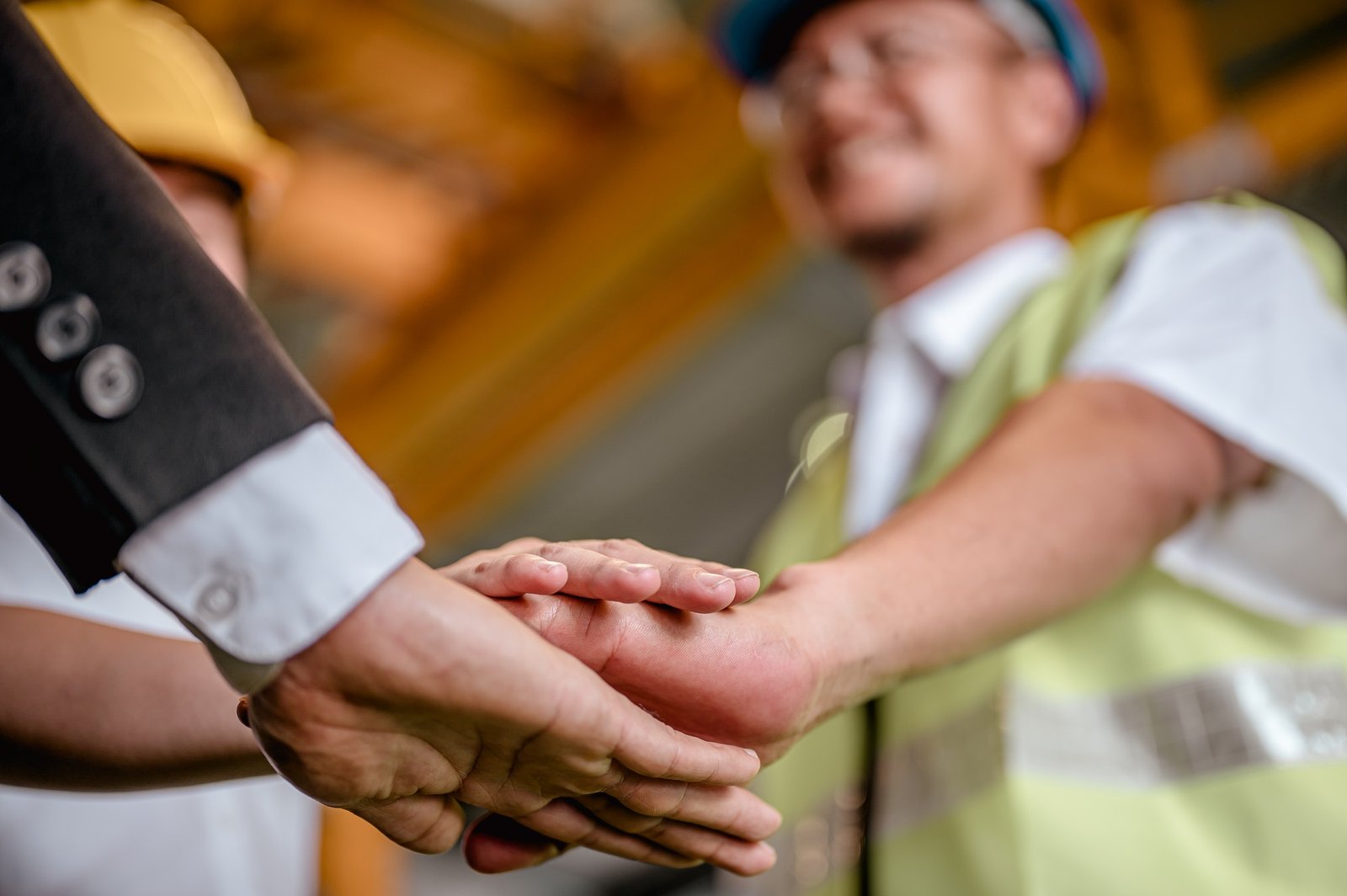 Hand coordination together of factory owner or manager, female specialist, and old worker in factory